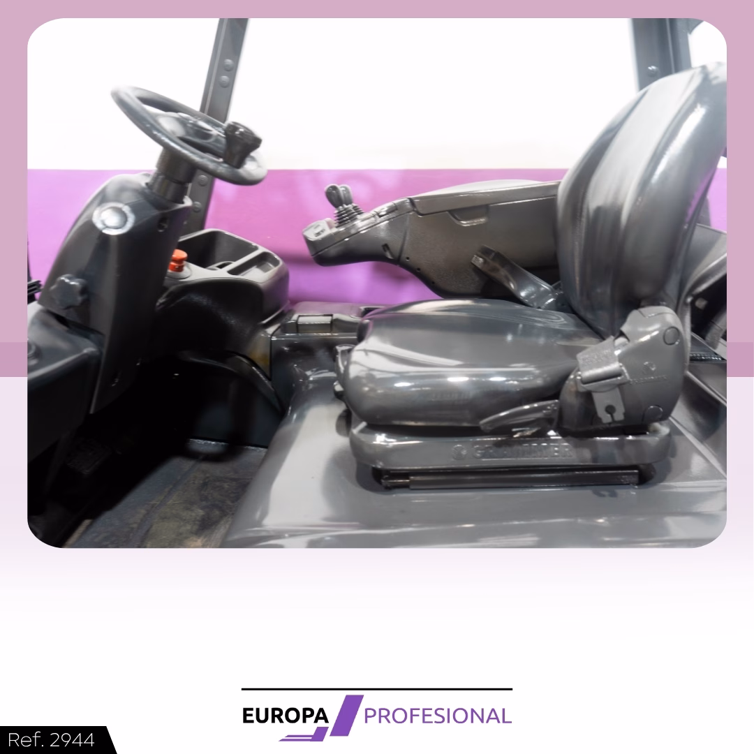 5 - EUROPA PROFESIONAL Gray forklift cab interior with steering wheel, seat, and lever controls.